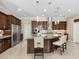 Gourmet kitchen features stainless steel appliances, a large center island, and custom cabinets at 2400 Trissino Ct, Henderson, NV 89044