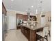 Modern kitchen featuring an island, granite countertops, stainless steel appliances, and stylish pendant lighting at 2400 Trissino Ct, Henderson, NV 89044