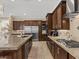 Modern kitchen with granite countertops, stainless steel appliances, and dark wood cabinetry at 2400 Trissino Ct, Henderson, NV 89044