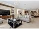 Open-concept living room with modern chandelier, built-in shelves, and tile flooring at 2400 Trissino Ct, Henderson, NV 89044