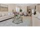Comfortable living room features stylish sofas, a chic coffee table, and an adjacent dining area with elegant chandelier at 2400 Trissino Ct, Henderson, NV 89044