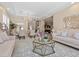 Inviting living room connects to dining space, showcasing chic sofas, a chandelier, and tasteful decor elements at 2400 Trissino Ct, Henderson, NV 89044