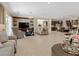 Open-concept living room with a fireplace, comfortable seating, and seamless flow to the kitchen area at 2400 Trissino Ct, Henderson, NV 89044