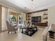 Relaxing living area featuring a large sliding glass door, neutral color palette, and ample natural light, great for entertaining at 2400 Trissino Ct, Henderson, NV 89044