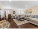 Spacious living room with hardwood floors, a modern rug, and sectional sofa at 2400 Trissino Ct, Henderson, NV 89044
