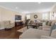 Comfortable living room with hardwood floors, a modern rug, and sectional sofa at 2400 Trissino Ct, Henderson, NV 89044