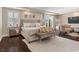 Enjoy a spacious main bedroom with large bed, seating, and TV at 2400 Trissino Ct, Henderson, NV 89044