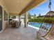 Spacious outdoor patio featuring comfortable seating, a dining area, and a relaxing swing, perfect for outdoor enjoyment at 2400 Trissino Ct, Henderson, NV 89044