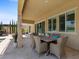 Charming outdoor patio with a dining set, offering a cozy space for al fresco meals and gatherings at 2400 Trissino Ct, Henderson, NV 89044