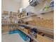 Well-stocked pantry with organized shelving, baskets, and ample storage space for groceries and household items at 2400 Trissino Ct, Henderson, NV 89044