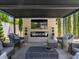 Inviting covered patio boasts comfortable seating, an outdoor fireplace, and a mounted TV, perfect for outdoor enjoyment at 2400 Trissino Ct, Henderson, NV 89044