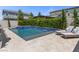 Relaxing backyard oasis features a refreshing pool, spa, lounge chairs, and lush landscaping for ultimate outdoor enjoyment at 2400 Trissino Ct, Henderson, NV 89044