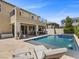 Gorgeous backyard features a pool with a spa, outdoor kitchen, lounge chairs and a patio for outdoor pleasure at 2400 Trissino Ct, Henderson, NV 89044
