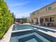 Stunning backyard showcases a pool, spa, and outdoor lounge area with picturesque views for luxurious outdoor living at 2400 Trissino Ct, Henderson, NV 89044