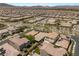 Expansive aerial view of a well-planned community with houses, landscaped streets, and mountain views in the distance at 2434 Quiet Ode St, Henderson, NV 89044