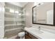 Well-lit bathroom featuring a shower and sink with wooden cabinets at 2434 Quiet Ode St, Henderson, NV 89044