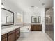 Bathroom featuring double vanity, standalone tub, and a tiled shower at 2434 Quiet Ode St, Henderson, NV 89044