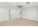 Bright bedroom with neutral carpet, ceiling fan, and views of the en suite at 2434 Quiet Ode St, Henderson, NV 89044