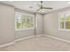 Carpeted bedroom with large shuttered windows and ceiling fan at 2434 Quiet Ode St, Henderson, NV 89044