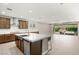 Stylish kitchen with a large island, stainless steel appliances, and seamless flow into the living area at 2434 Quiet Ode St, Henderson, NV 89044