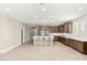 Spacious kitchen with dark wood cabinets, stainless steel appliances, and large center island with seating at 2434 Quiet Ode St, Henderson, NV 89044