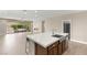 Kitchen island with stainless sink overlooks open floor plan and outdoor patio seating area at 2434 Quiet Ode St, Henderson, NV 89044