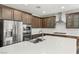 Kitchen with stainless appliances, wood cabinets, and a center island offers space for cooking at 2434 Quiet Ode St, Henderson, NV 89044