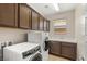 Well-equipped laundry room featuring a washer, dryer, storage cabinets and sink with sleek countertop at 2434 Quiet Ode St, Henderson, NV 89044