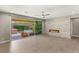 Spacious living area with sliding glass doors to the patio and a contemporary fireplace with stone surround at 2434 Quiet Ode St, Henderson, NV 89044