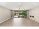 Bright living room featuring modern fireplace, sliding glass doors to patio, and neutral tile flooring at 2434 Quiet Ode St, Henderson, NV 89044