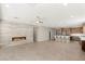 Open-concept living room featuring a modern fireplace, ceiling fan, and seamless flow into the kitchen area at 2434 Quiet Ode St, Henderson, NV 89044