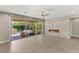 Spacious living area with sliding glass doors to the patio and a contemporary fireplace with stone surround at 2434 Quiet Ode St, Henderson, NV 89044