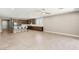 Bright living space with an open floor plan, neutral tile flooring, and a modern kitchen island with seating at 2434 Quiet Ode St, Henderson, NV 89044