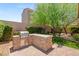 Outdoor kitchen with built-in grill and stone countertop, perfect for entertaining in the backyard at 2434 Quiet Ode St, Henderson, NV 89044