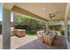 Enjoy outdoor living with a built-in grill, comfortable seating around a fire pit on the covered patio at 2434 Quiet Ode St, Henderson, NV 89044