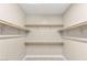 Spacious walk-in closet equipped with shelving and hanging rods at 2434 Quiet Ode St, Henderson, NV 89044