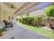 Relaxing covered patio overlooking an artificial lawn and an outdoor water feature at 2545 Nashira St, Henderson, NV 89044