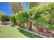 Well-manicured backyard with artificial turf, garden beds, and seating at 2545 Nashira St, Henderson, NV 89044