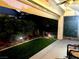 Picturesque backyard featuring lush greenery, stone fountain, and covered patio at 2545 Nashira St, Henderson, NV 89044