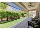 Covered patio overlooking backyard with artificial turf, and stone fountain at 2545 Nashira St, Henderson, NV 89044