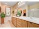 Bathroom with dual sinks, decorative mirrors, and a glass-enclosed shower at 2545 Nashira St, Henderson, NV 89044