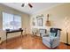 Bedroom with wooden floors, guitars, and an armchair at 2545 Nashira St, Henderson, NV 89044