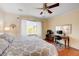 Comfortable bedroom with a neutral palette, hardwood floors, and a window overlooking greenery at 2545 Nashira St, Henderson, NV 89044