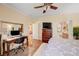 Spacious bedroom features hardwood floors and an open doorway leading to an ensuite bathroom at 2545 Nashira St, Henderson, NV 89044