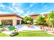 Picturesque courtyard featuring outdoor seating, landscaped with trees, and decorative cactus pots at 2545 Nashira St, Henderson, NV 89044