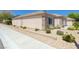 Attractive home exterior featuring stone accents, desert landscaping, and a sidewalk at 2545 Nashira St, Henderson, NV 89044