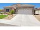 Charming single-story home featuring a stone facade, well-manicured landscaping, and a two-car garage at 2545 Nashira St, Henderson, NV 89044