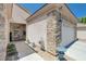 Attractive home exterior featuring stone accents, desert landscaping, and an attached garage at 2545 Nashira St, Henderson, NV 89044