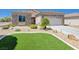 Charming home with a stone facade, well-manicured landscaping and artificial grass at 2545 Nashira St, Henderson, NV 89044