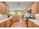 Well-lit kitchen featuring stainless steel appliances, wood cabinetry, and a view of the patio at 2545 Nashira St, Henderson, NV 89044
